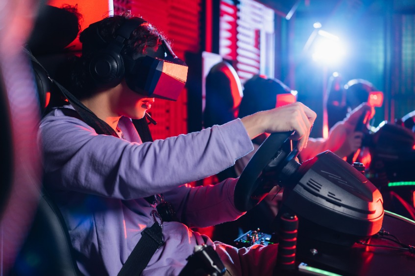 teenage boy in vr headset playing racing game on car simulator boy in vr headset playing racing game on car simulator