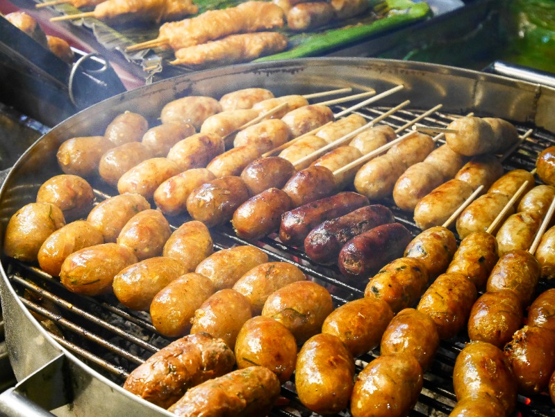 Thai sausage grilling on the stove focus same point have smoke Thai sausage grilling